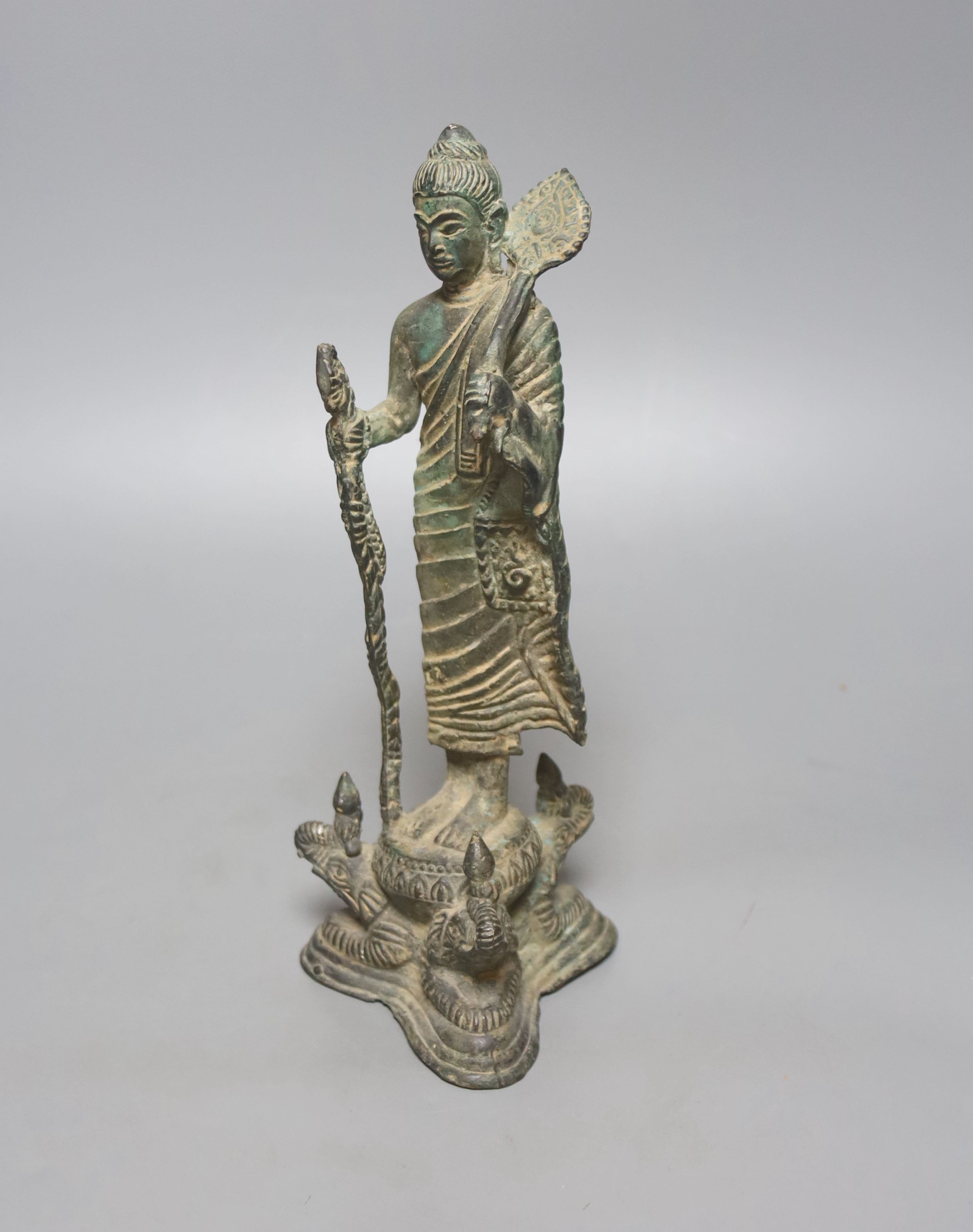 An Indian bronze figure of a standing Buddha, 25cm